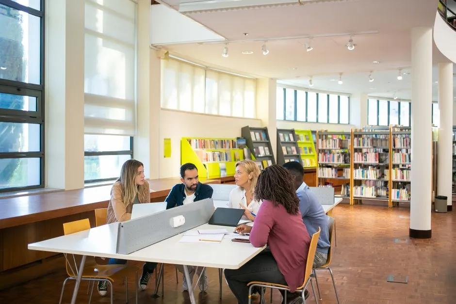 Students researching together at a table in a library